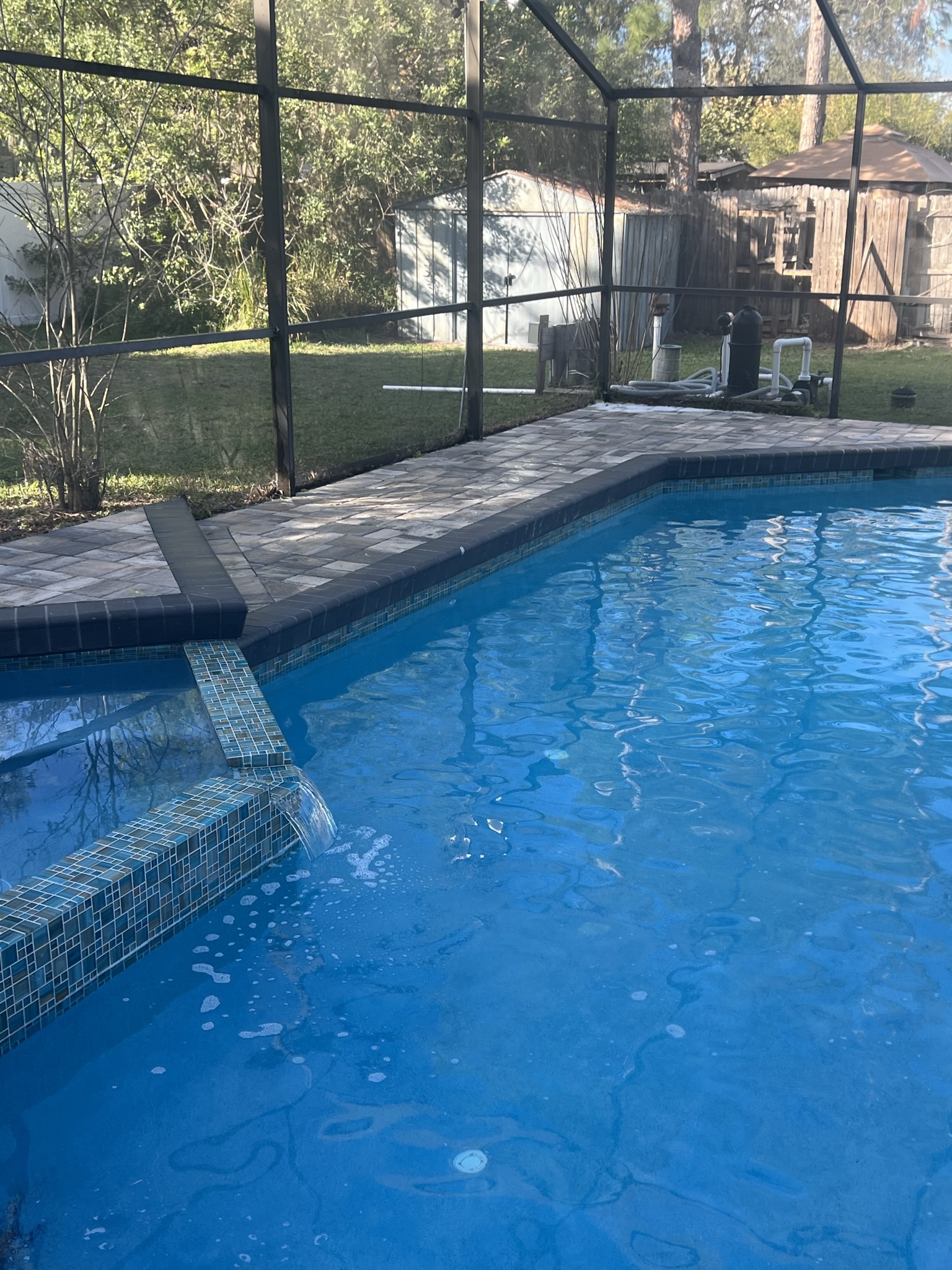 Pool design consultation meeting with client reviewing blueprints